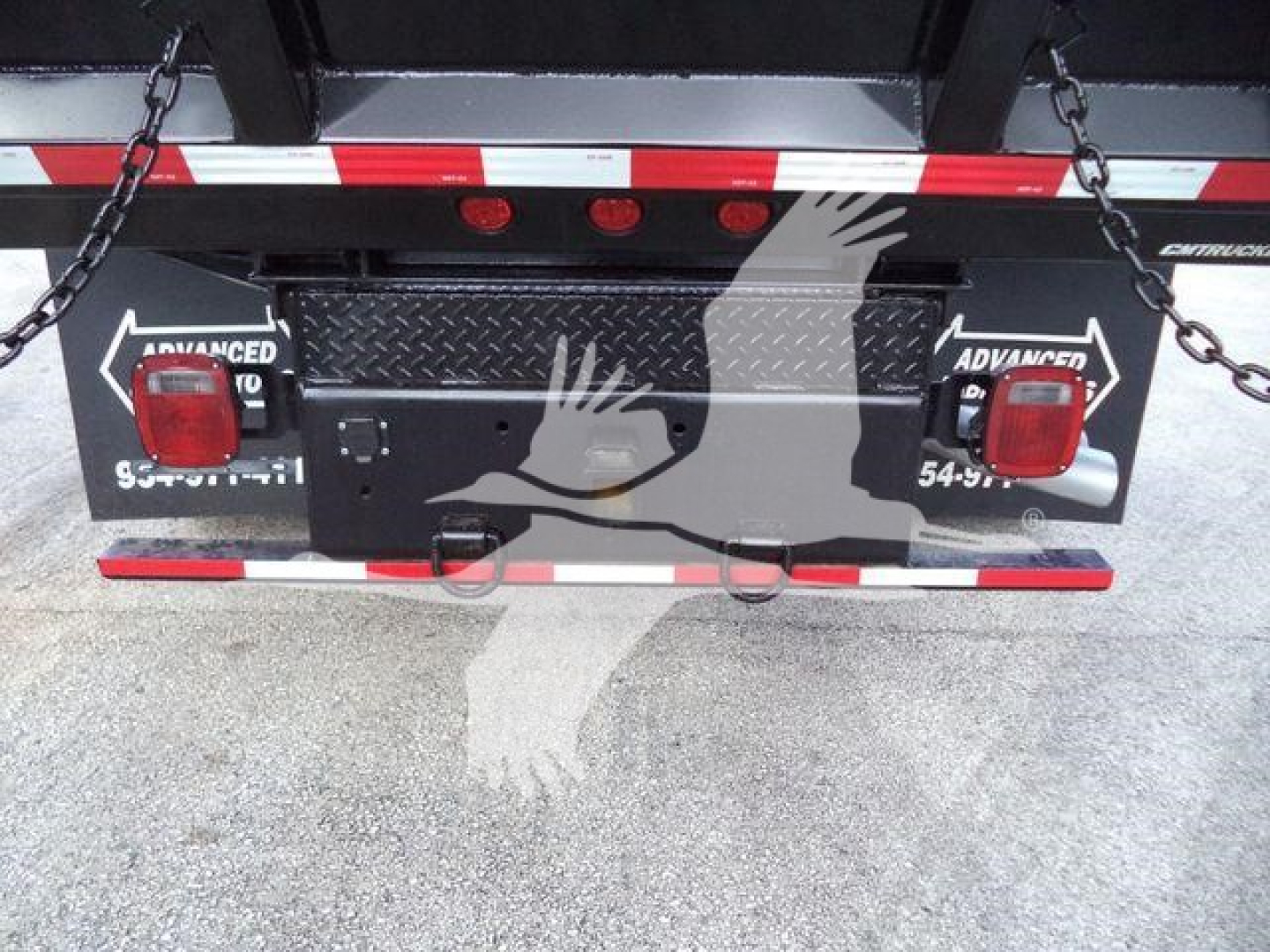 Rear view of a 2018 Ford F550 XL dump truck showing the tailgate with chain hooks, lights, and reflective tape. Stock plate area visible.