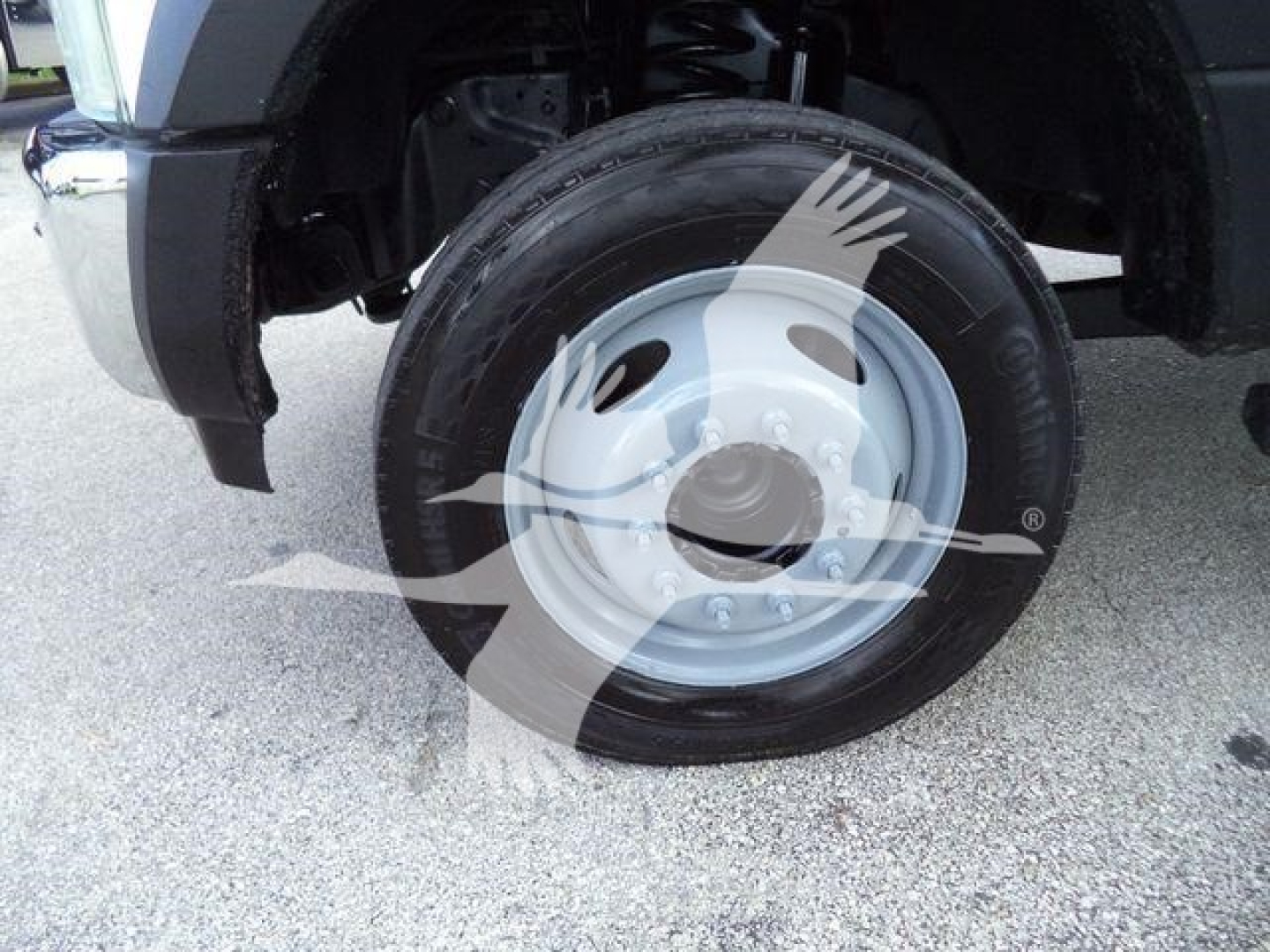 Ford F-550 front wheel and tire assembly showing steel wheel and tire tread in a truck wheel well.