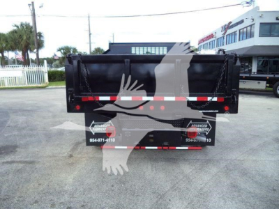 Dump truck bed back view showing black dump bed, reflective tape, and rear lights.