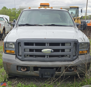 Front view of a white 2005 Ford F-350 XL Super Duty dump truck showing grille and bumper details.