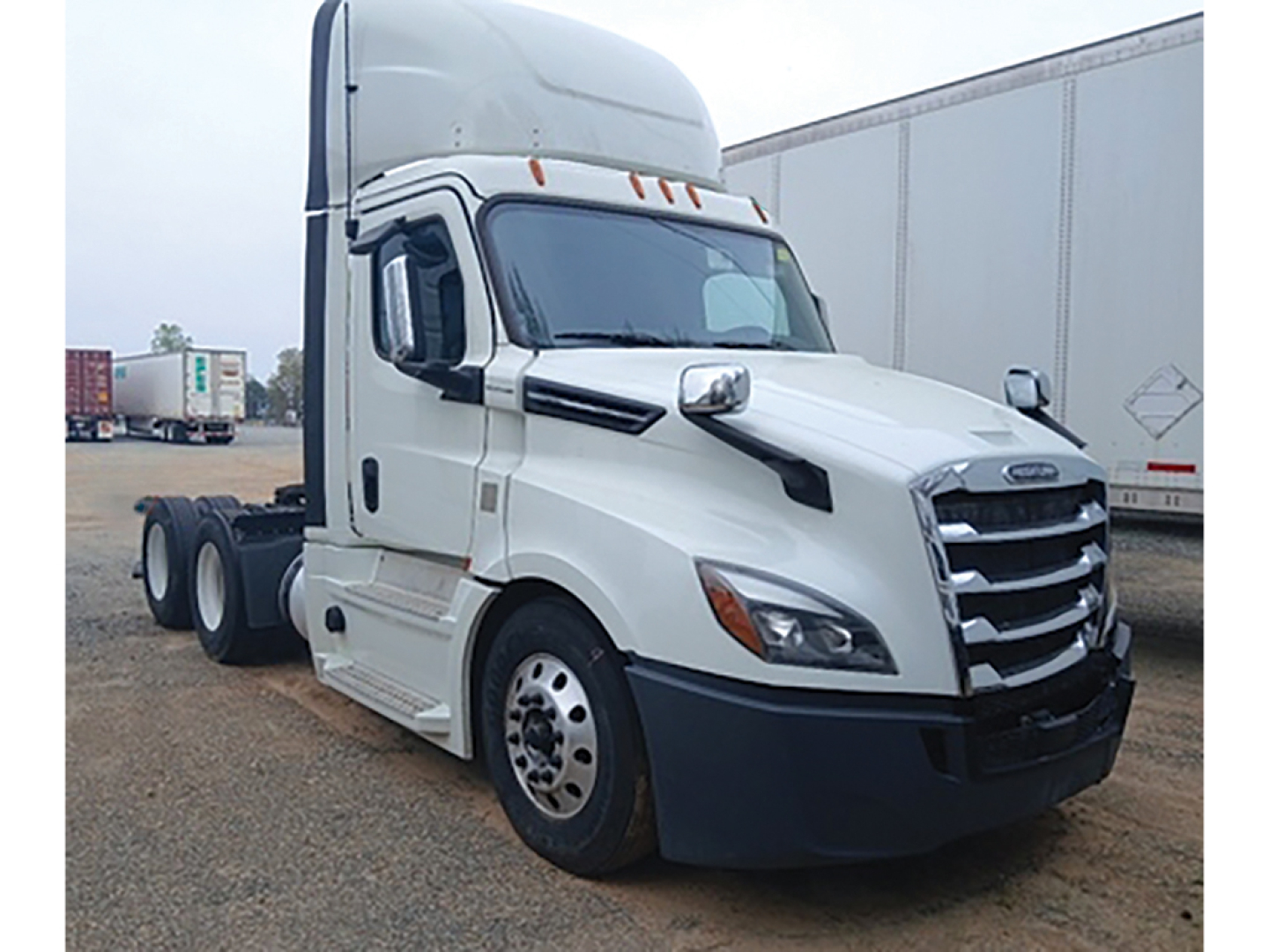 Truck cab showing white 2020 Freightliner Cascadia126 sleeper tractor with chrome grille and black bumper, daycab configuration.