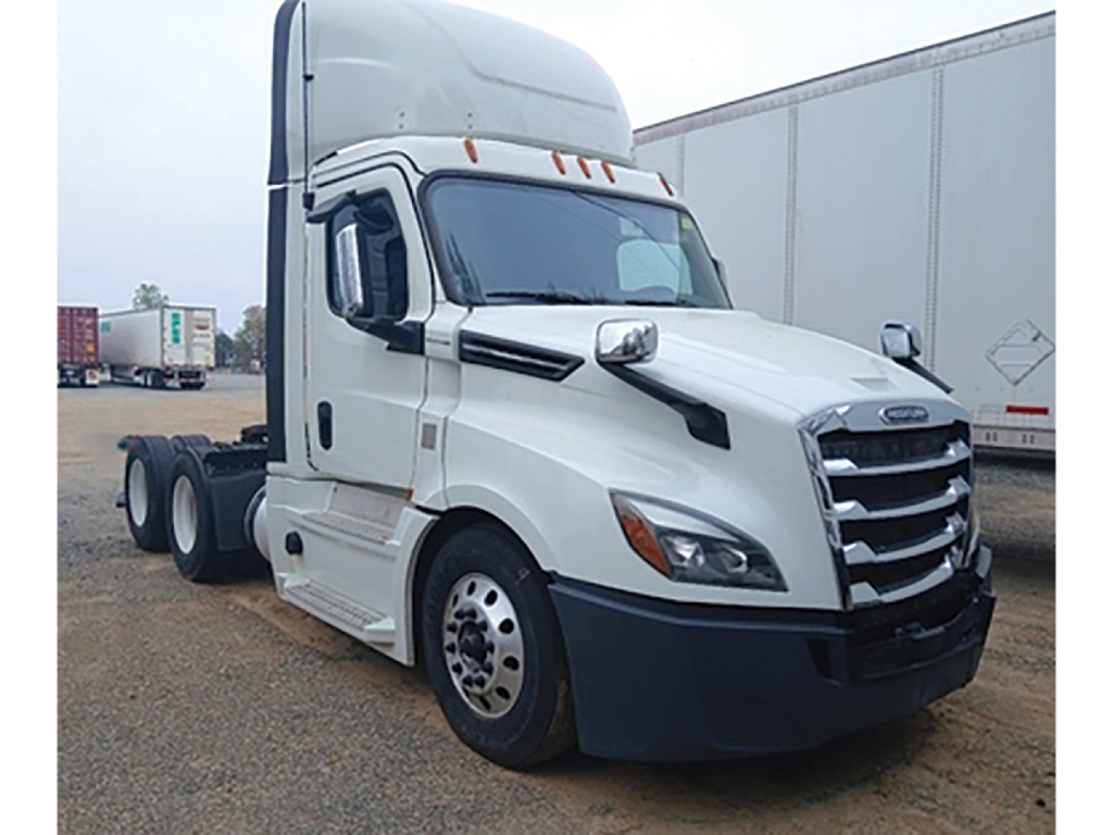 Truck cab showing white 2020 Freightliner Cascadia126 sleeper tractor with chrome grille and black bumper, daycab configuration.