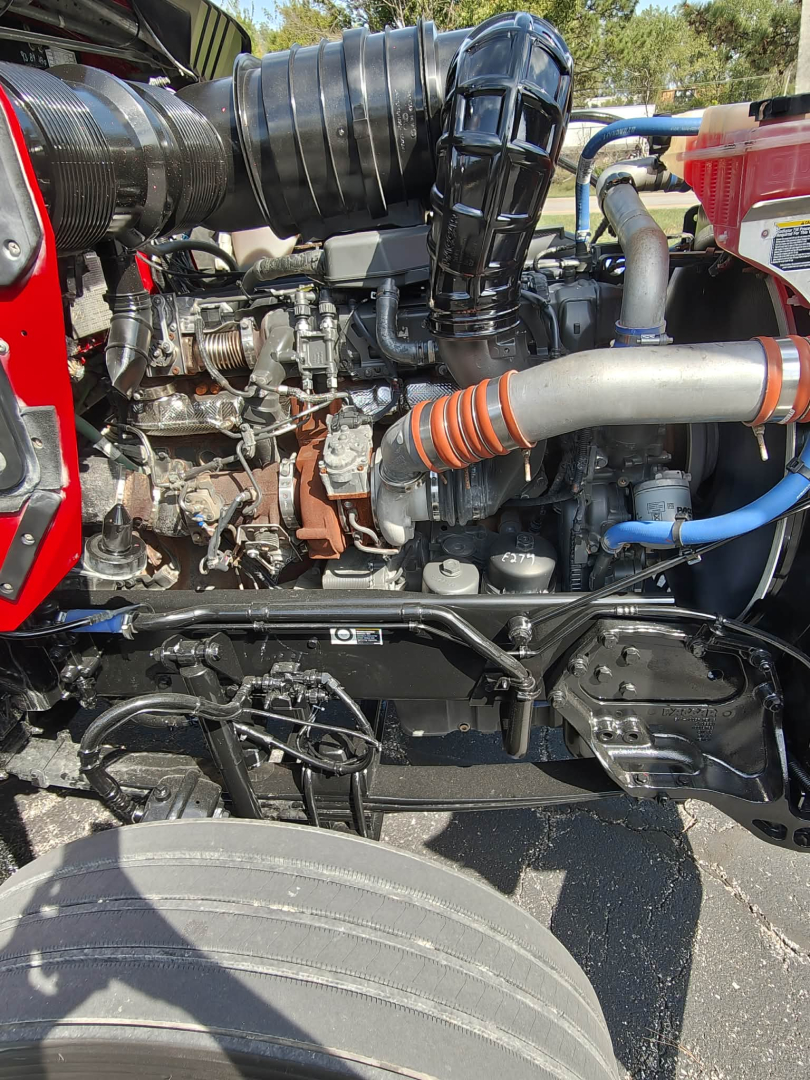 Kenworth T800 engine bay showing diesel engine components, hoses, turbocharger, and intake. Visible labels and wiring in-service condition.