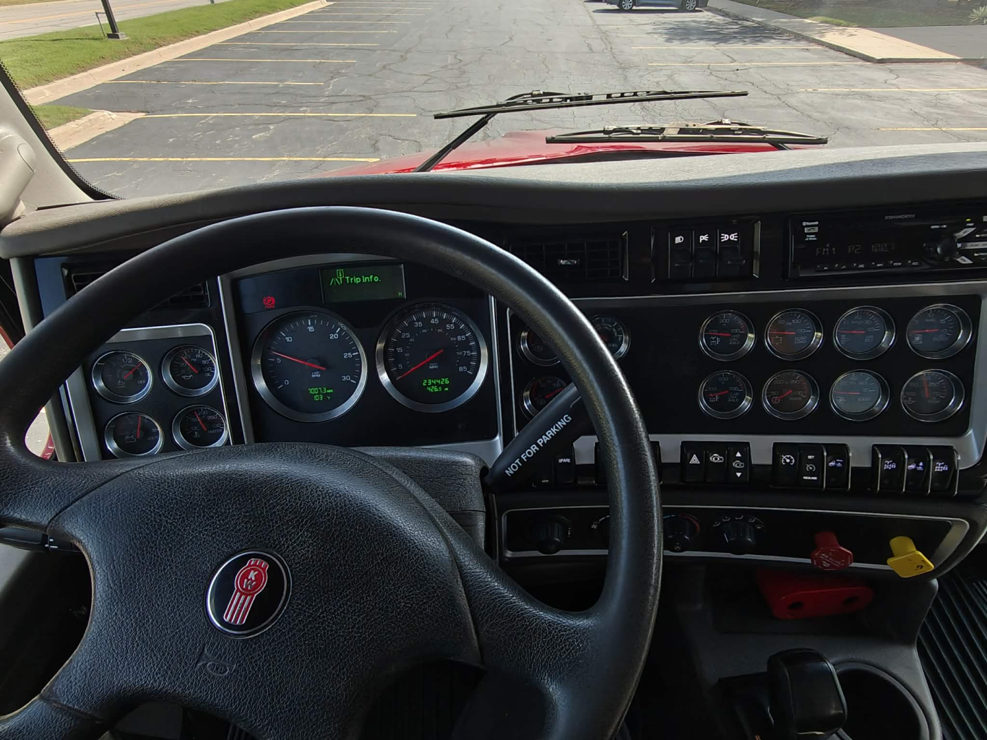 Kenworth T800 truck interior dashboard and steering wheel with multiple gauges and controls.