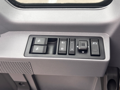 Mack PI64 cabin interior window and control switches showing door lock, mirror, window controls, and dash toggle switches.