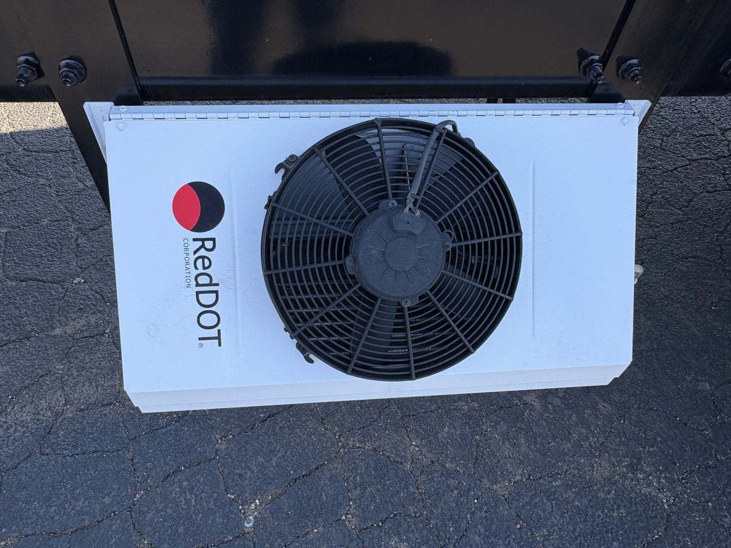 Radiator with RedDOT cooling fan mounted on a white panel, circular fan guard, RedDOT branding visible.