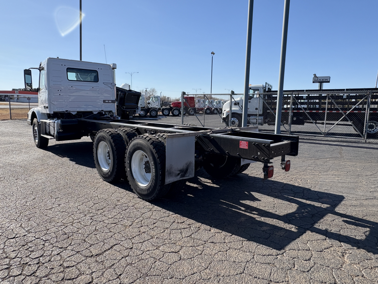 Volvo VHD64B300 chassis rear view showing dual rear axles and flatbed frame.