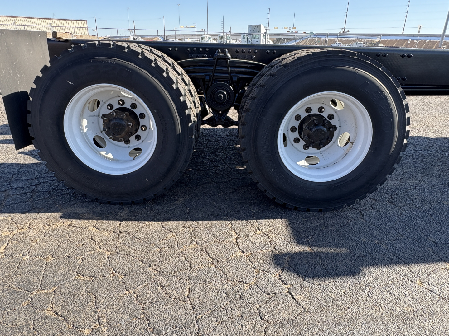 Dual rear truck wheels on a Volvo VHD64B300 chassis showing dual tires and wheel rims.