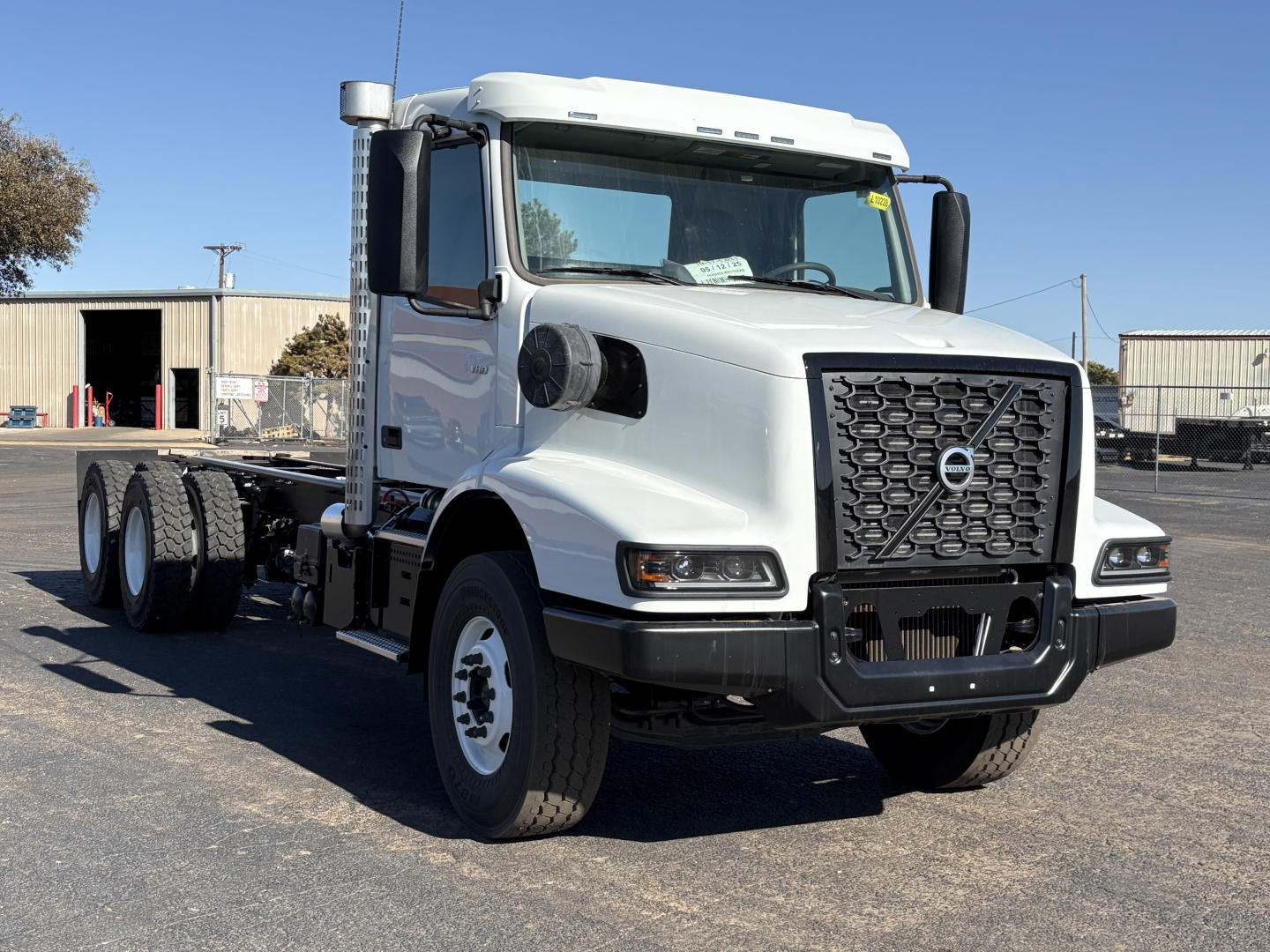 Volvo VHD64B300 truck in front view showing grille, headlights, large side mirrors, and dual rear axles.
