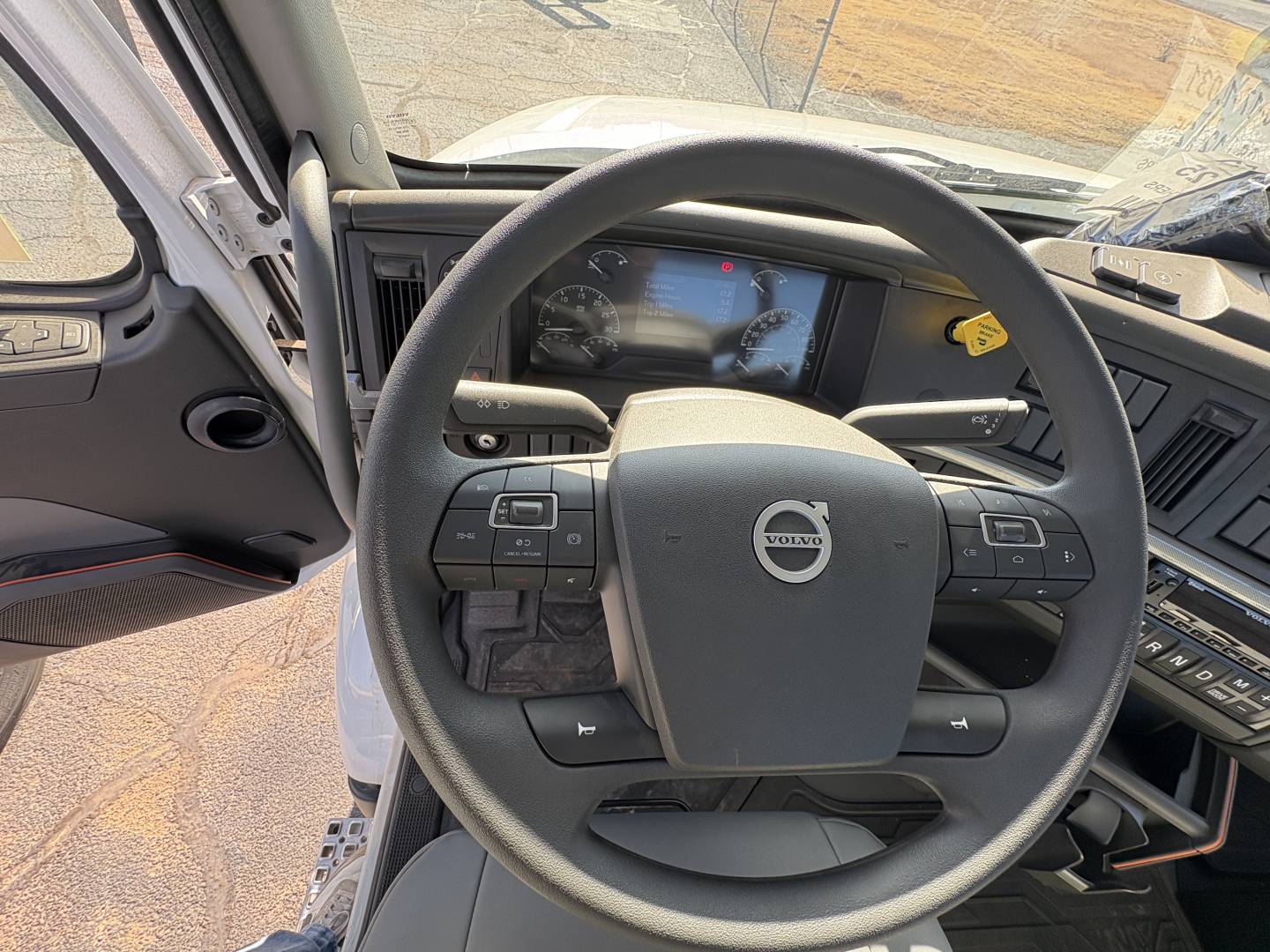 Volvo VHD64B300 truck interior steering wheel and dashboard view.