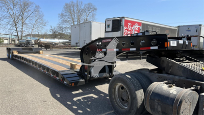 Fontaine XN20 lowboy trailer with gooseneck coupling and long flatbed deck visible; side rails and wheel fender; VIN 13N653206V35A7010 and stock V35A7010; front cab area shows hydraulic components and ramps.