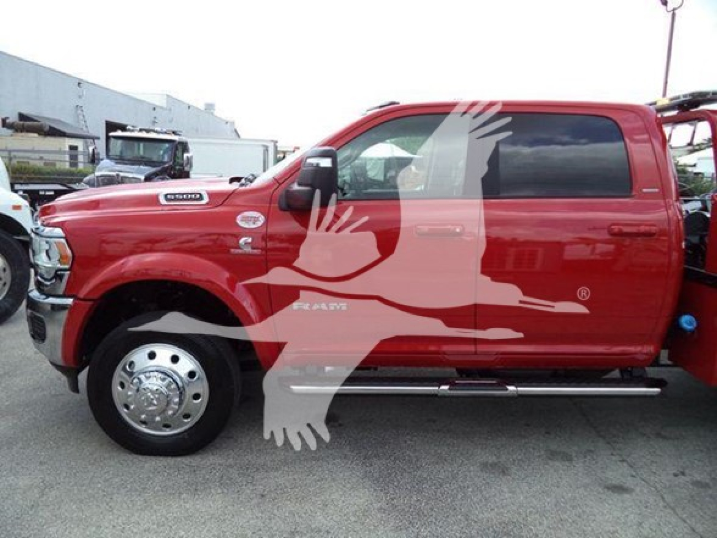 Ram pickup truck side view showing red exterior and black-tinted windows with stock features and equipment decals.