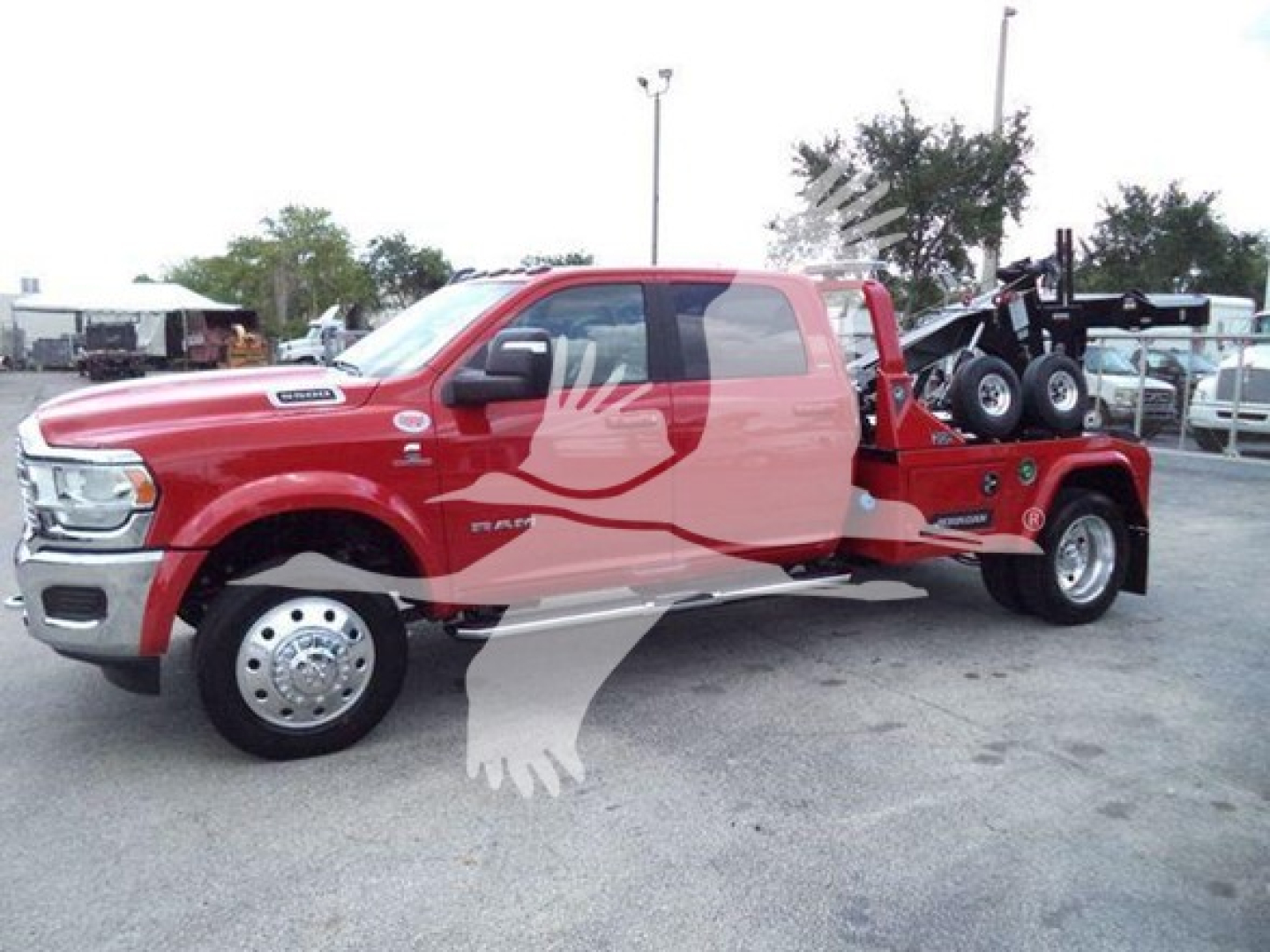 Ram 3500 heavy-duty pickup with winch rear, red cab and flatbed tow setup, side view highlighting the truck and winch-equipped rear section.