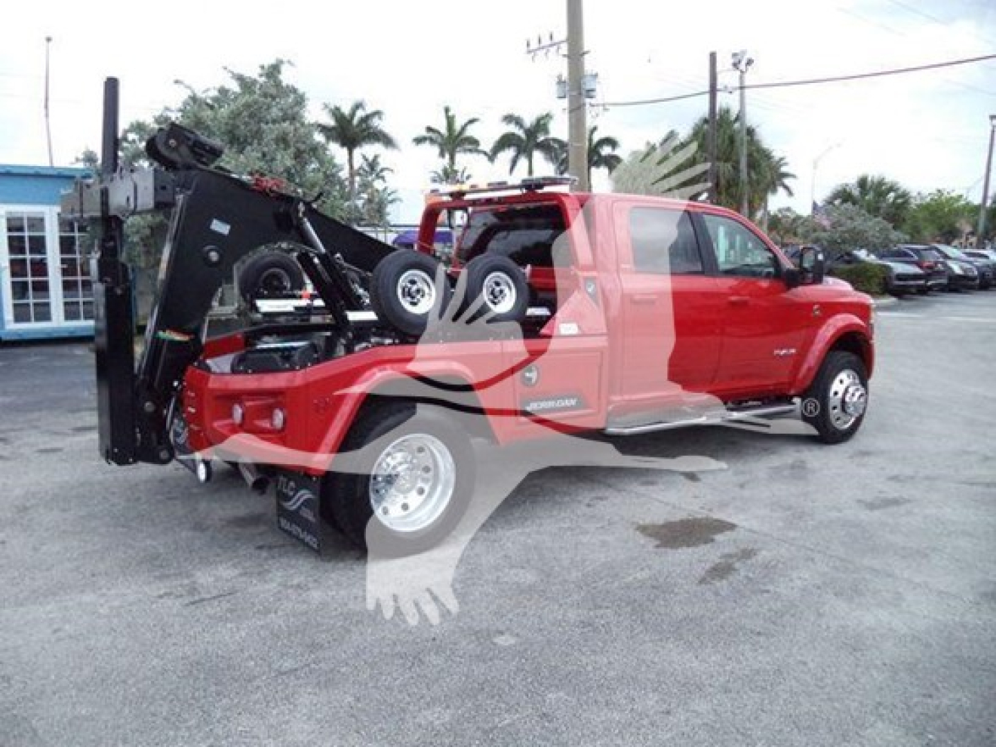 Ram pickup with winch-equipped bed and folded ramp system showing rear and side profiles.