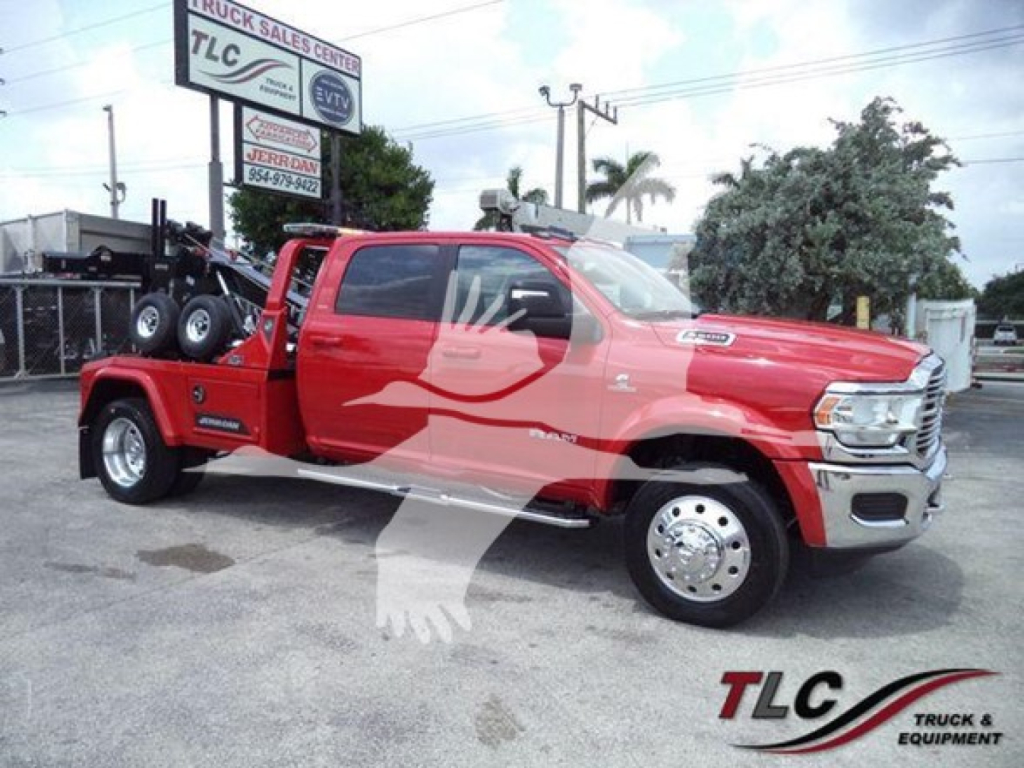 Ram pickup truck with a winch setup on a flatbed, red color, stock number J40123, front grille and chrome wheels visible.
