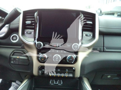 Ram pickup interior dashboard and center console showing touchscreen display, climate controls, and gear selector area.