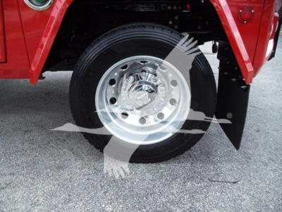 Ram truck wheel and tire close-up under red fender, chrome rim with hub, black side step edge, and mud flap visible.