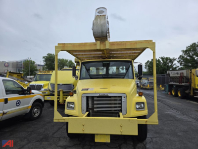Front view of a yellow 2003 Freightliner FL70 bucket truck with Altec aerial lift; large rectangular grille, headlights, and platform frame visible.