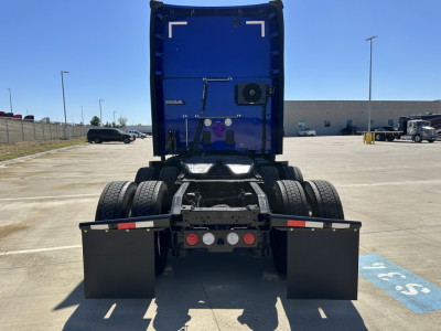 Kenworth T680 rear view showing fifth wheel and dual rear axles with mud flaps and LED lights.