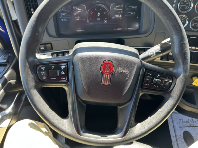 Kenworth T680 steering wheel and dashboard with instrument gauges visible, including steering wheel controls on both sides.