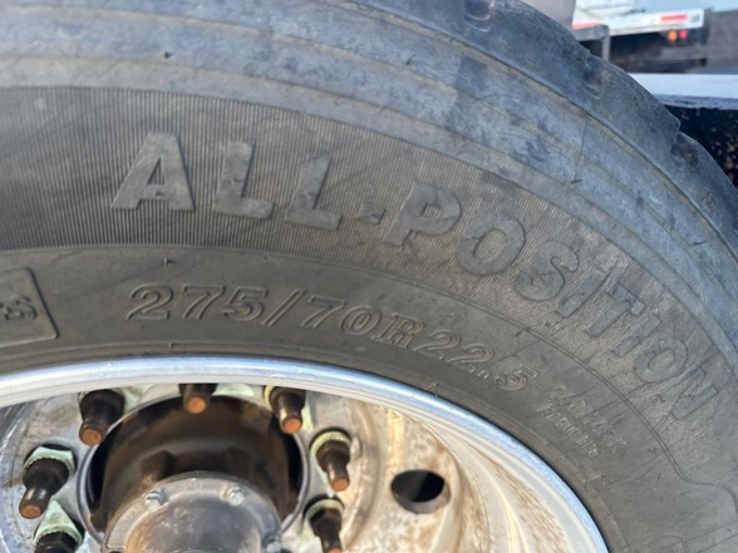 Trailer wheel with tire showing 'ALL-POSITION' and size markings '275/70R22.5' on sidewall.