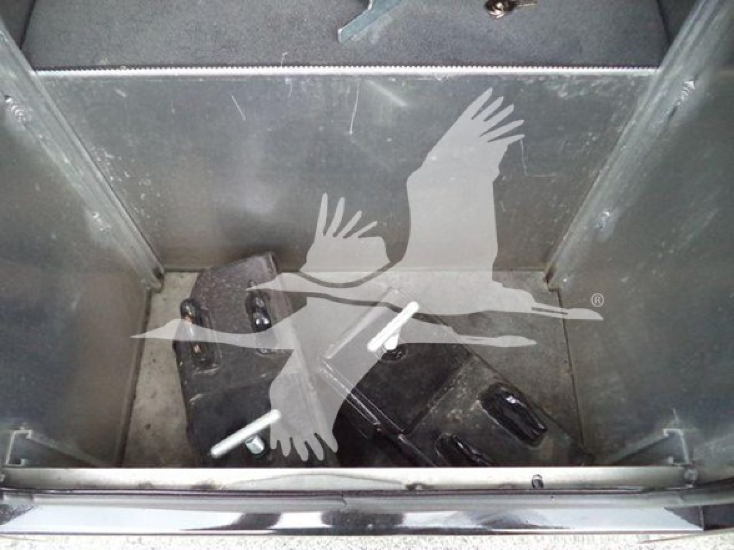 Winch-equipped Freightliner M2 106 interior storage area with two black boxes and white tag stickers visible.