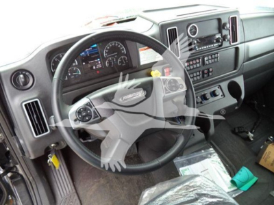 Freightliner M2 106 truck interior showing steering wheel and instrument cluster with dashboard controls.