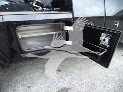 Freightliner M2 106 side fuel/tool compartment door open showing storage cavity and latch.