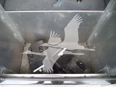 Winch-equipped Freightliner M2 106 interior storage area with two black boxes and white tag stickers visible.