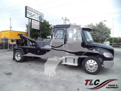 Freightliner M2 106 tow truck side view showing winch and crane apparatus, cab with chrome steps and dual rear wheels.