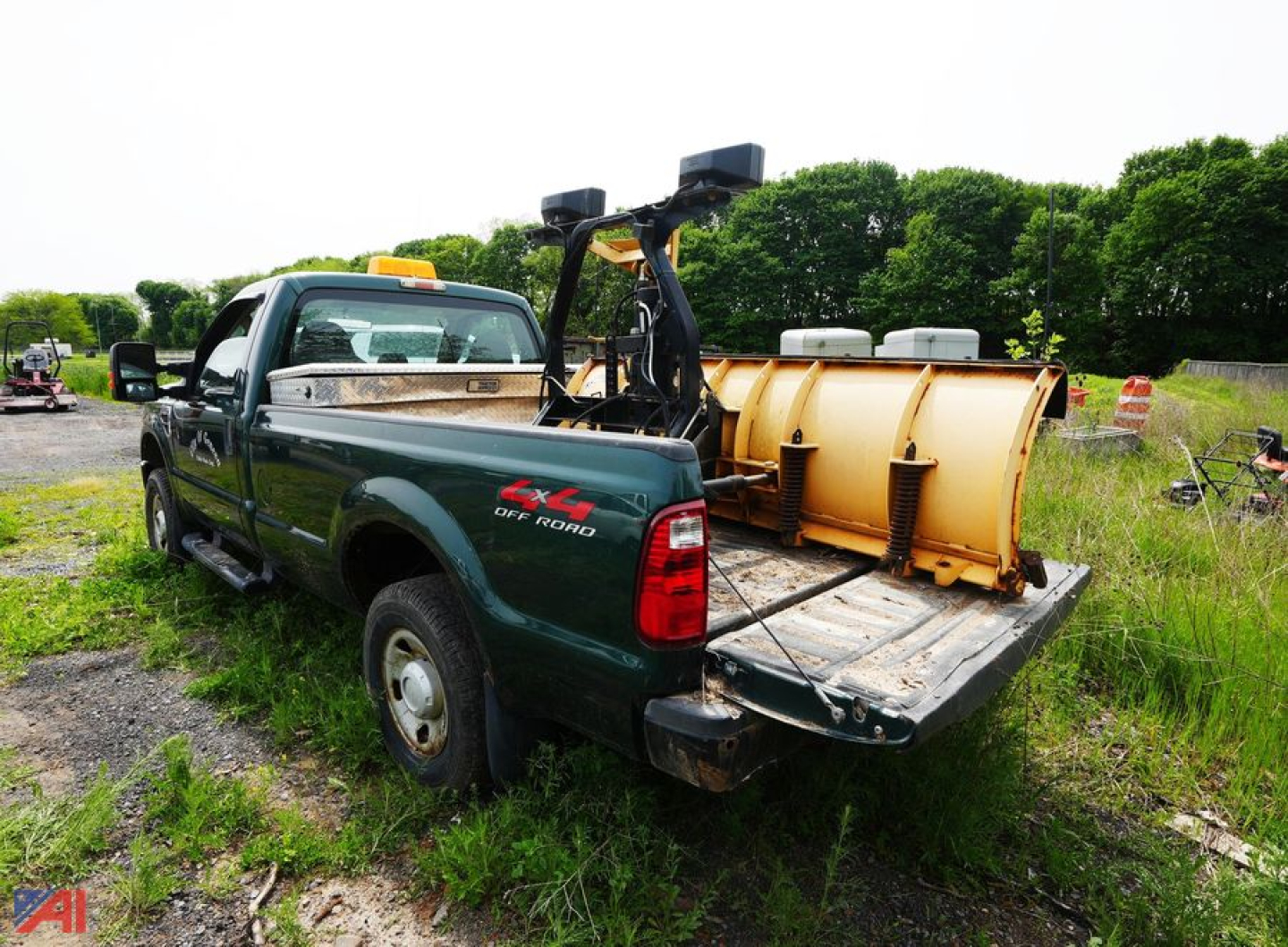2009 Ford F-250 XL Super Cab pickup with snowplow mount and plow blade in field