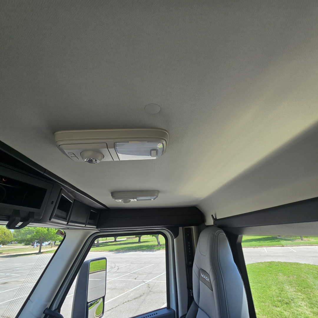 Cab interior of a 2027 Mack AN64T cab showing overhead console and interior roof lining.