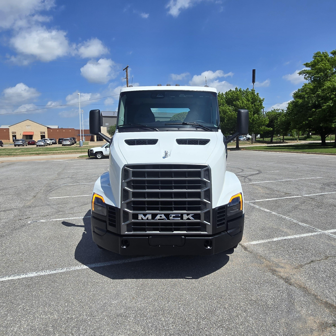 Front view of a white 2027 Mack AN64T conventional daycab truck with large grille and Mack emblem, headlights, and bumper.