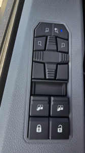 Truck cab window controls panel with window/lock switches visible, vertical arrangement
