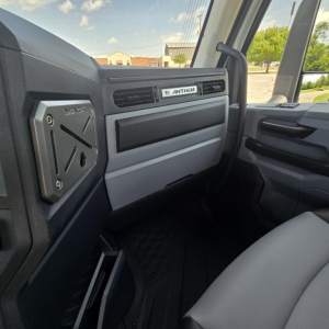 Mack AN64T dash area and passenger visor showing ANTHEM badge, interior view of truck cab.