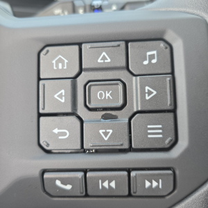 Dashboard navigation keypad with OK button and navigation arrows, showing square keys and molded controls.
