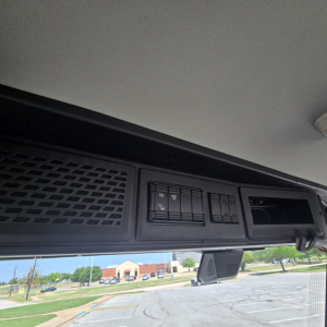 Interior overhead control panel view in Mack AN64T daycab showing dashboard controls and small display cavity.