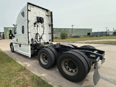 Truck chassis and cab of a Freightliner Cascadia125 tandem rear, showing rear wheels and fifth wheel area, side view with sleeper cab.