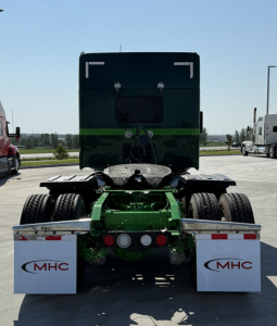 Kenworth W990 truck rear view showing chassis and dual rear axles with mud flaps labeled MHC.