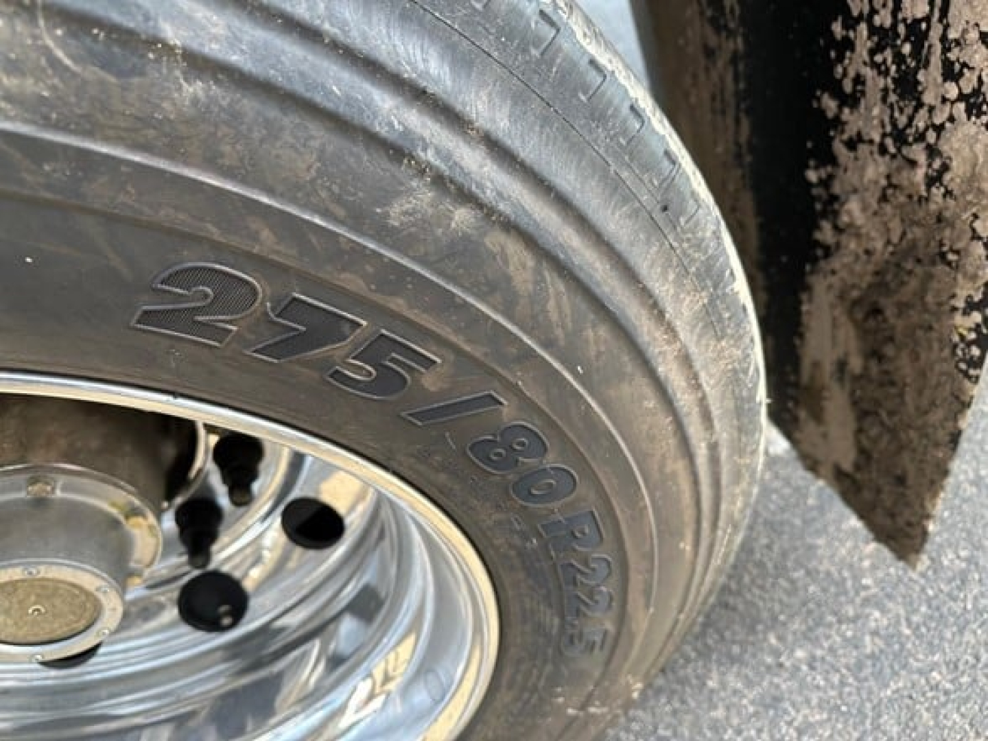 Trailer tire with visible tire markings 275/80R22.5 on the wheel