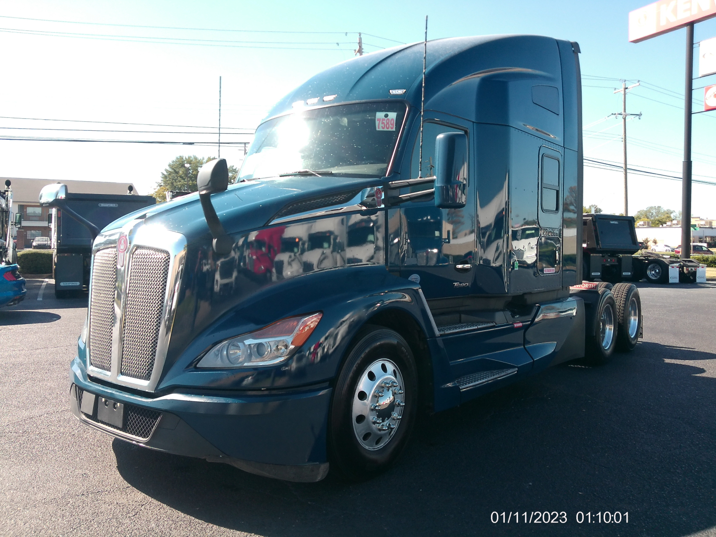 Kenworth T680 truck in blue, front-left view, with sleeper cab and dual rear axles, VIN sticker location visible.