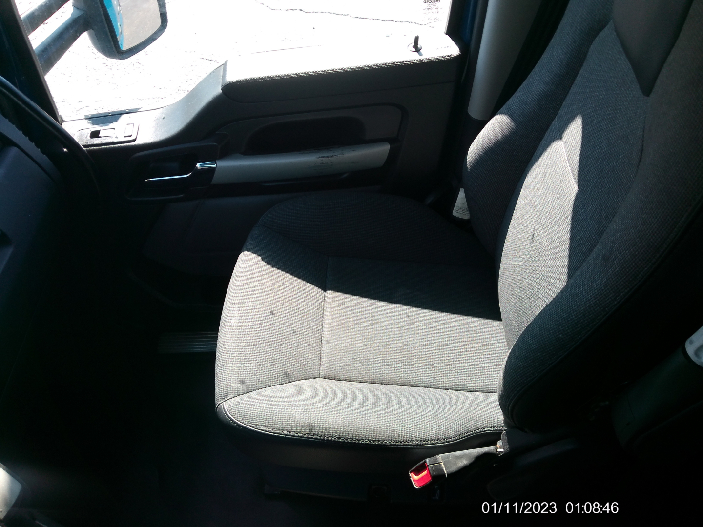 Kenworth T680 interior driver seat and door panel with timestamp 01/11/2023 01:08:46.