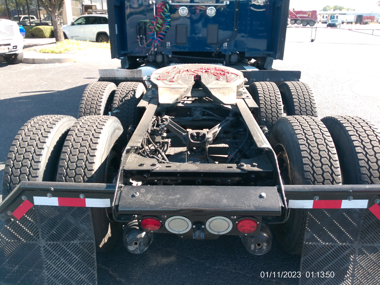 Kenworth truck rear view showing Fifth wheel, dual rear axles, and taillight cluster.
