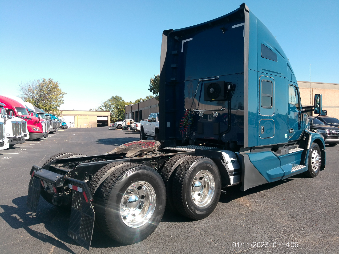 Kenworth T680 6x4 sleepered tractor rear view showing dual rear axles and blue cab with exhaust stack.