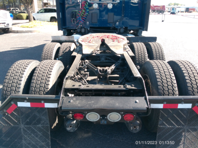 Kenworth truck rear view showing Fifth wheel, dual rear axles, and taillight cluster.
