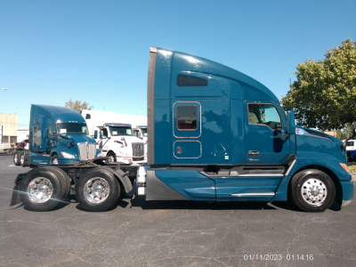 Kenworth T680 sleeper cab truck in blue, side view, with rear wheel duals visible. Date stamp 01/11/2023 01:14:16.