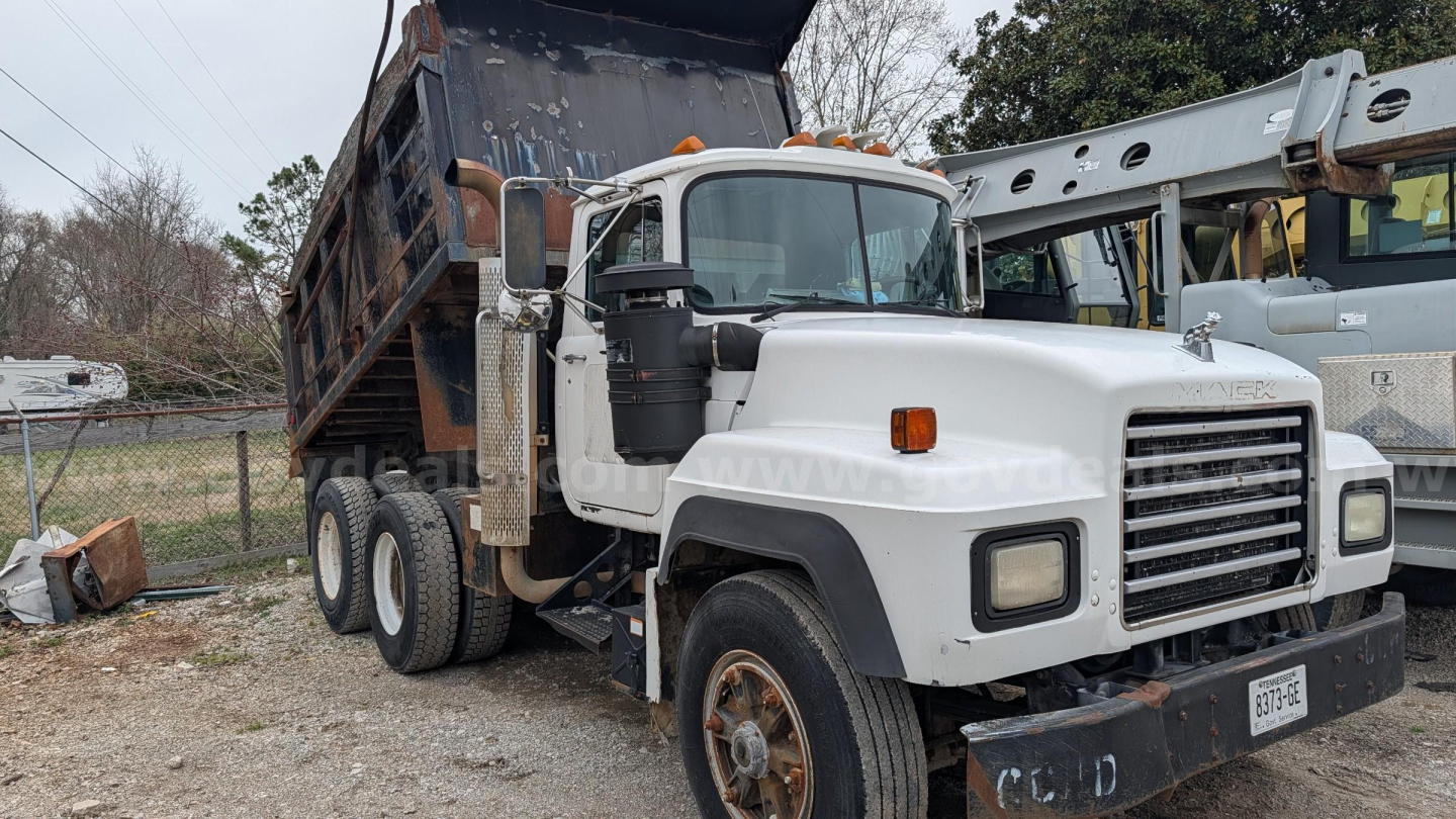 Mack RD690S dump truck in-service showing front grille, dual rear wheels, and a raised dump bed.