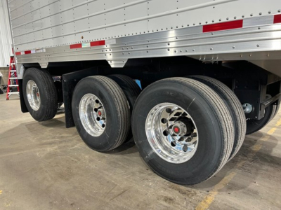 Timpte Super Hopper trailer axles and wheels shown with dual rear wheels and chrome rims.