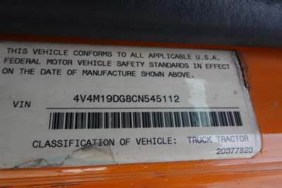Label on vehicle showing VIN 4V4M19DG8CN545112 and classification text including 'THIS VEHICLE CONFORMS... CLASSIFICATION OF VEHICLE: TRUCK TRACTOR'