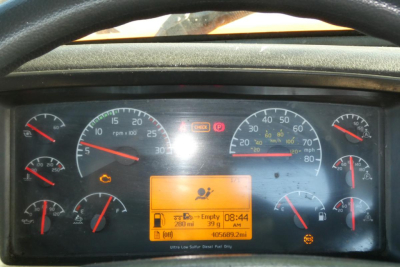 Dashboard of a Volvo VNM truck showing multiple gauges and an orange display panel with time 08:44 and mileage 405689.2mi.